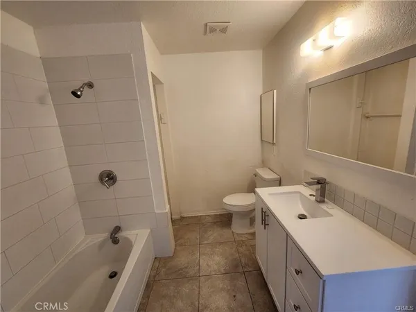 a bathroom with a double vanity sink toilet and shower