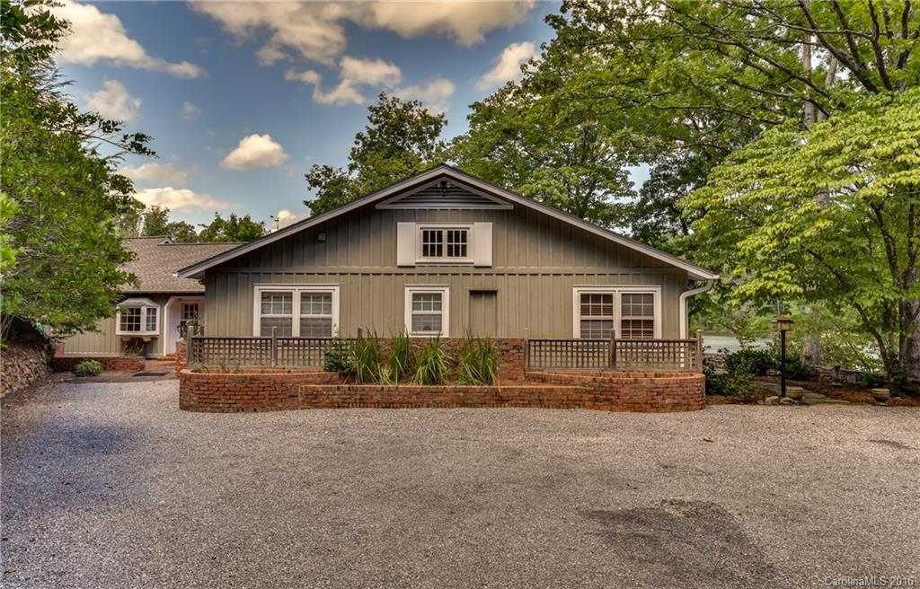 711 Green Hills Road Mill Spring, NC 28756 - Photo 1 of 23 a view of a house with a yard and large trees