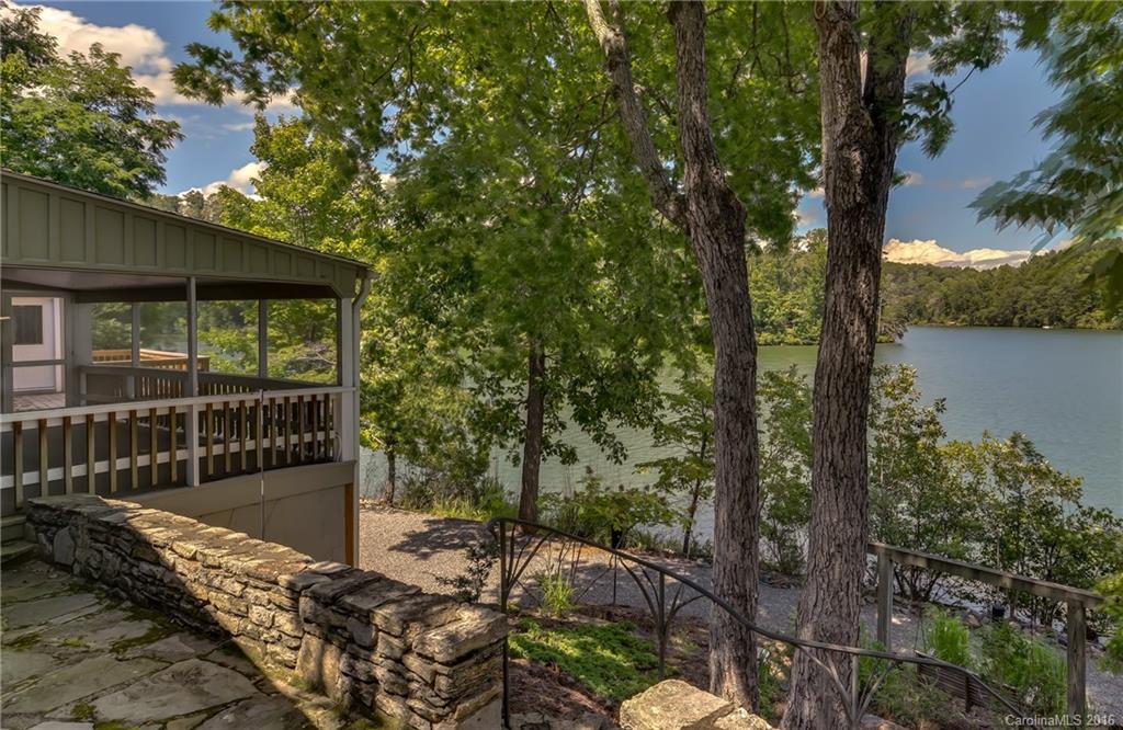 711 Green Hills Road Mill Spring, NC 28756 - Photo 2 of 23 a view of a deck with a large tree
