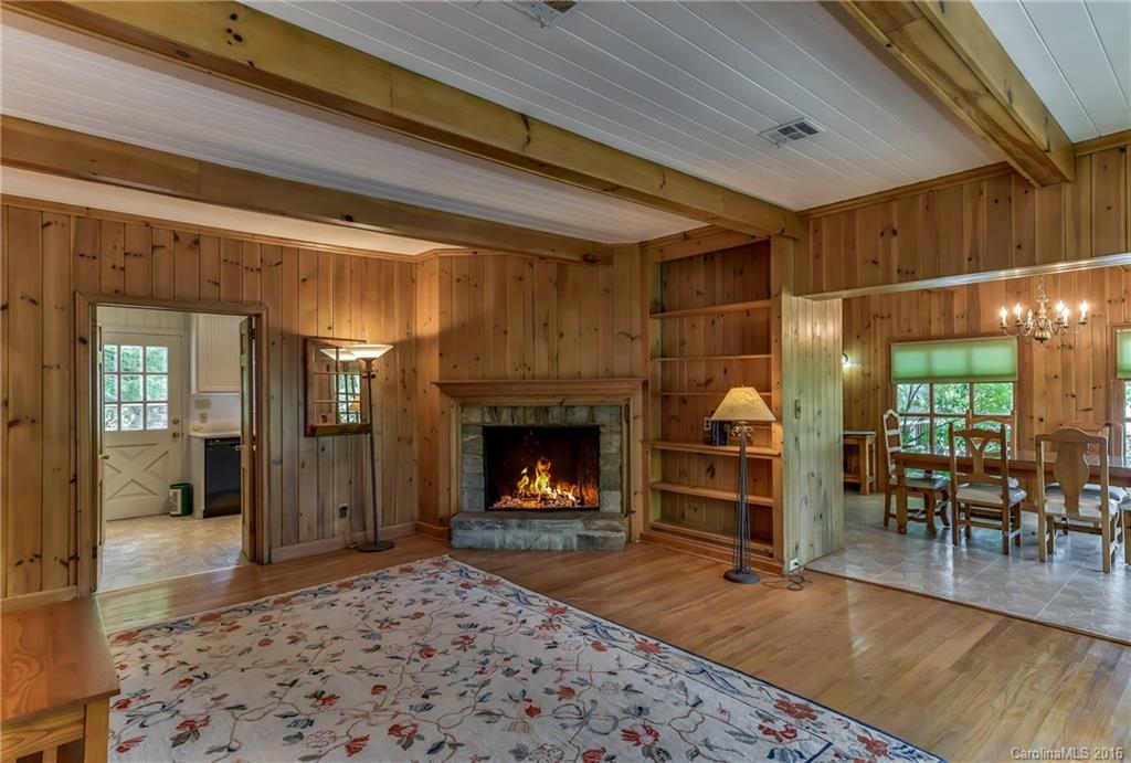 711 Green Hills Road Mill Spring, NC 28756 - Photo 12 of 23 a living room with furniture a fireplace and a table