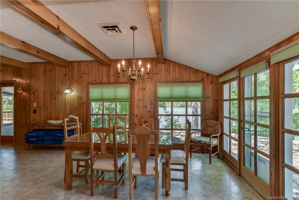 711 Green Hills Road Mill Spring, NC 28756 - Photo 13 of 23 a view of a dining room with furniture a chandelier and wooden floor