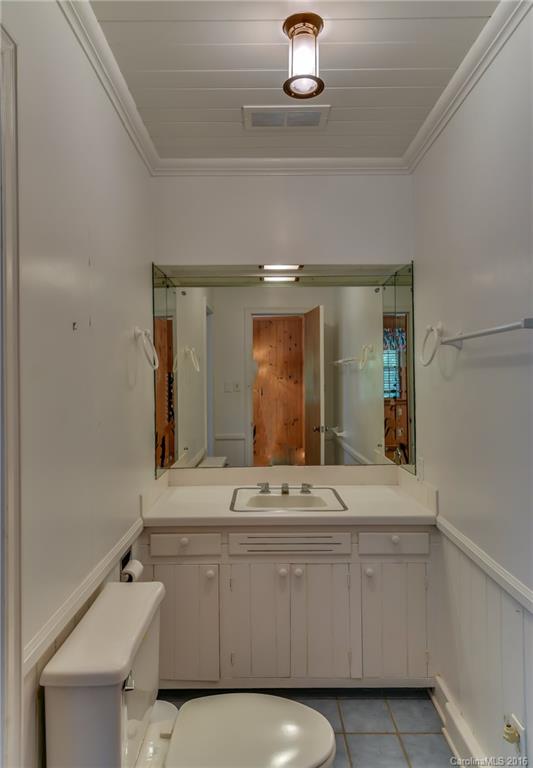 711 Green Hills Road Mill Spring, NC 28756 - Photo 18 of 23 a bathroom with a sink and a mirror