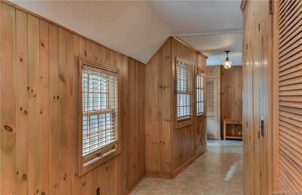 711 Green Hills Road Mill Spring, NC 28756 - Photo 19 of 23 a view of a hallway with wooden shelves