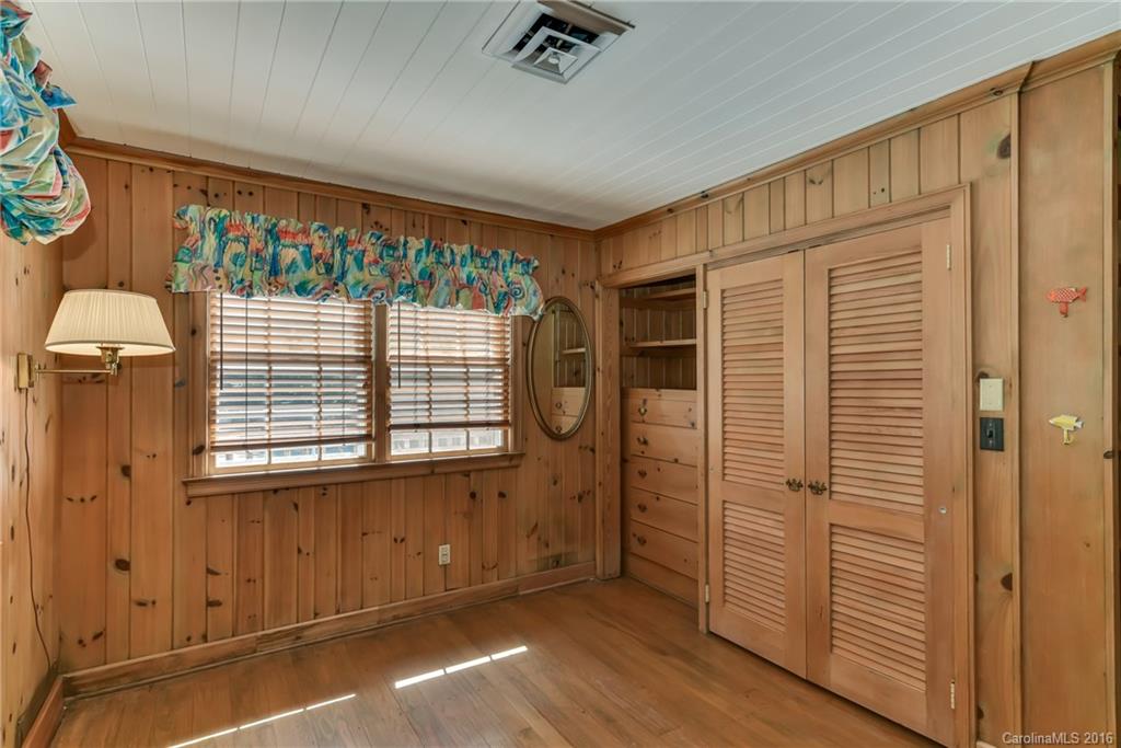 711 Green Hills Road Mill Spring, NC 28756 - Photo 20 of 23 an empty room with wooden floor and windows