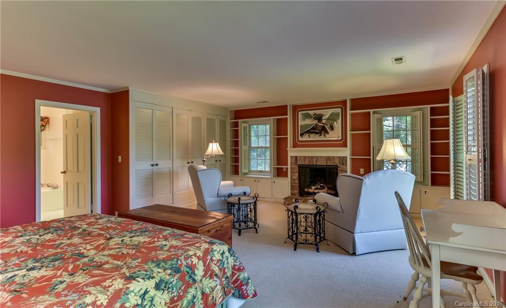 711 Green Hills Road Mill Spring, NC 28756 - Photo 22 of 23 a bedroom with furniture and a fireplace