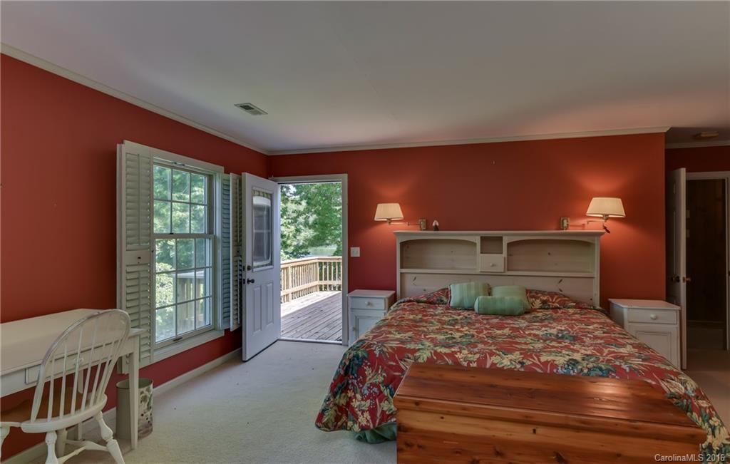 711 Green Hills Road Mill Spring, NC 28756 - Photo 23 of 23 a bedroom with a large bed and large window