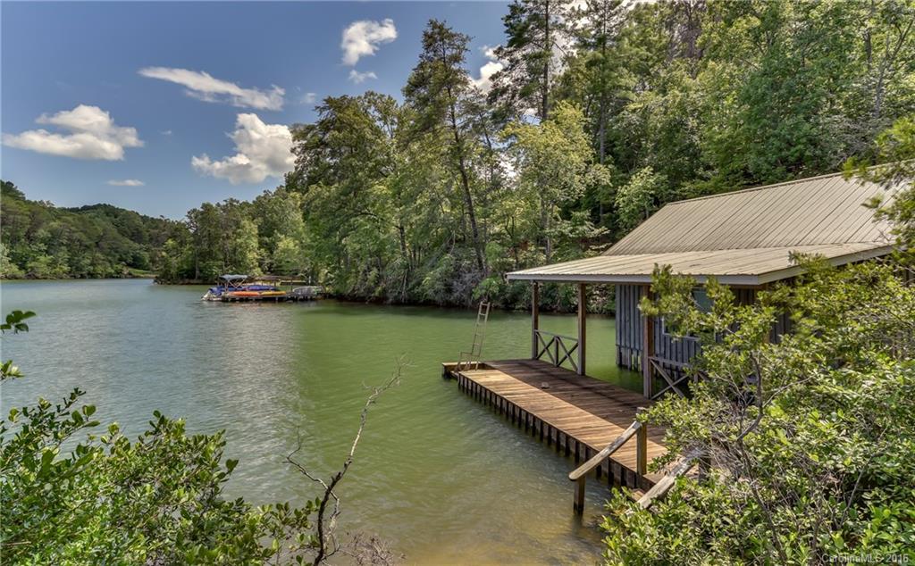 711 Green Hills Road Mill Spring, NC 28756 - Photo 6 of 23 an aerial view of a house with a table chair and lake view