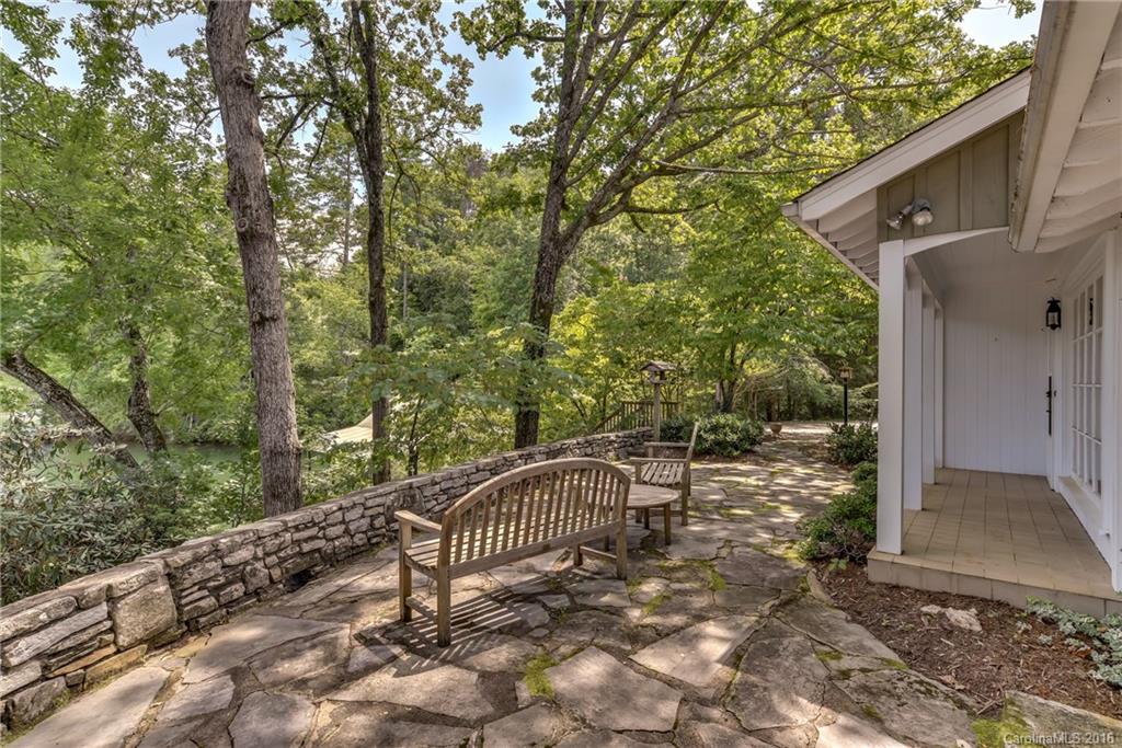 711 Green Hills Road Mill Spring, NC 28756 - Photo 9 of 23 a view of a bench in the backyard with large trees