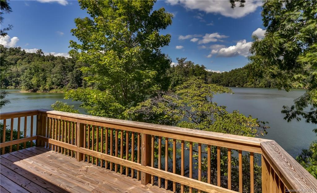 711 Green Hills Road Mill Spring, NC 28756 - Photo 10 of 23 a balcony with wooden floor and yard in the back