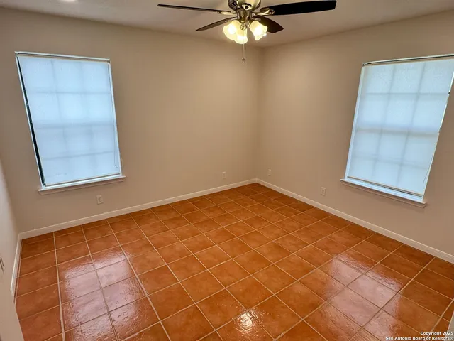 an empty room with kitchen view