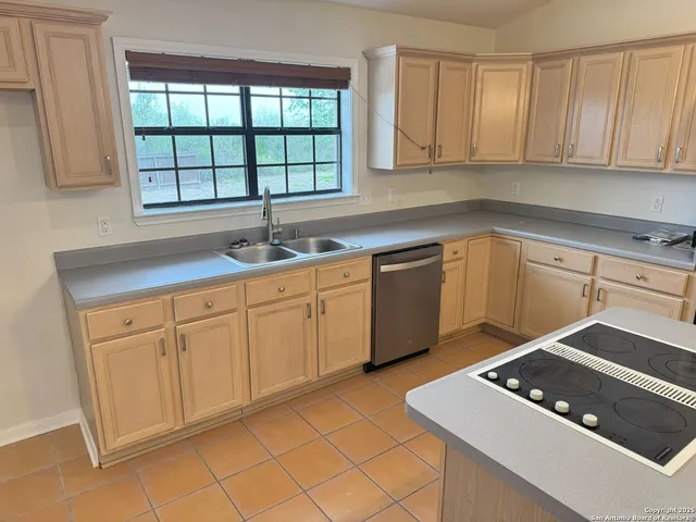 a kitchen with a sink and cabinets