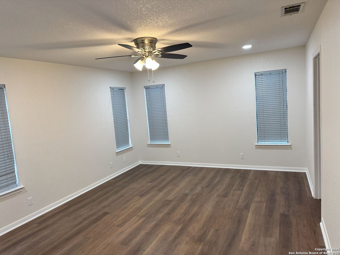 136 Lk Vw Terrace Three Rivers, TX 78071 - Photo 8 of 20 a view of an empty room with wooden floor and a window