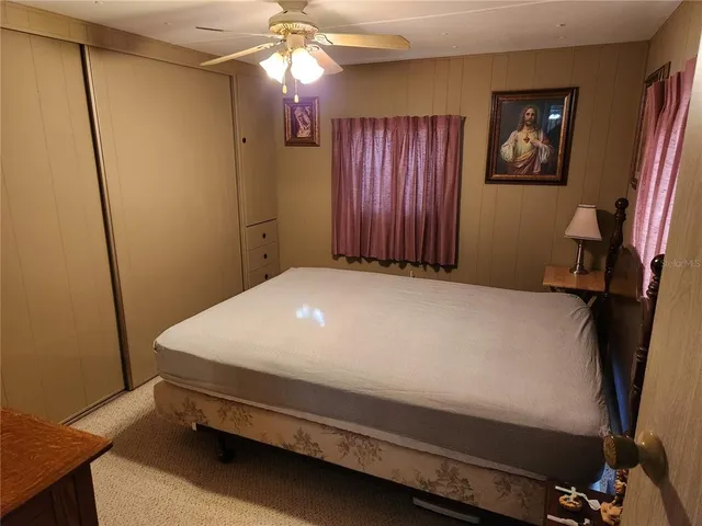 a bed sitting in a bedroom next to a window