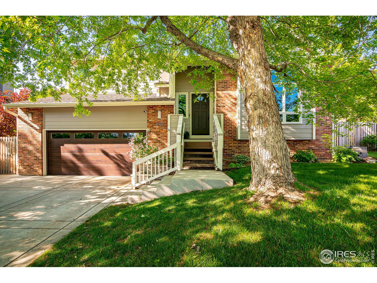 a view of a house with a yard and tree s