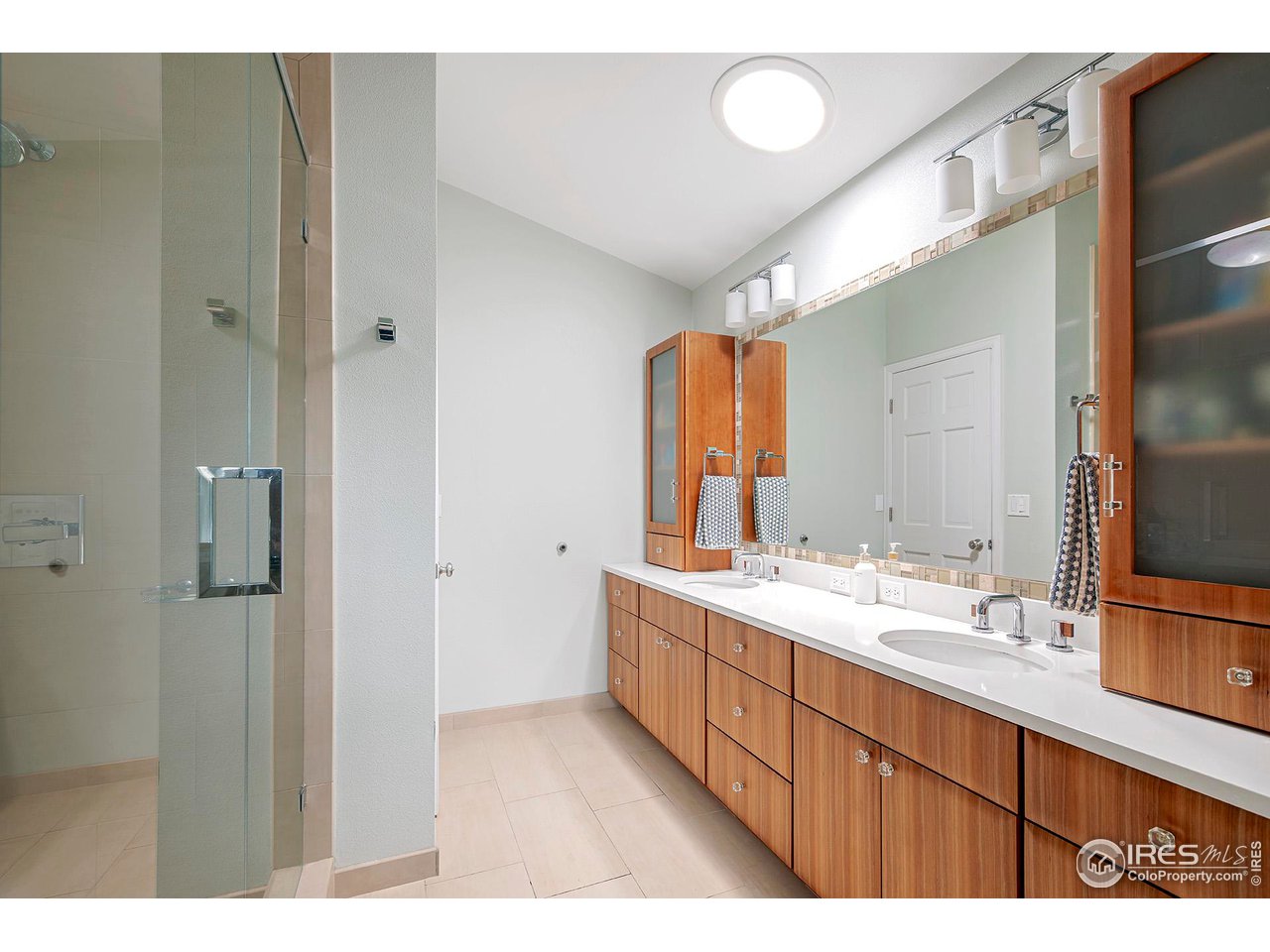 476 Locust Place Boulder, CO 80304 - Photo 24 of 38 a bathroom with a double vanity sink and mirror