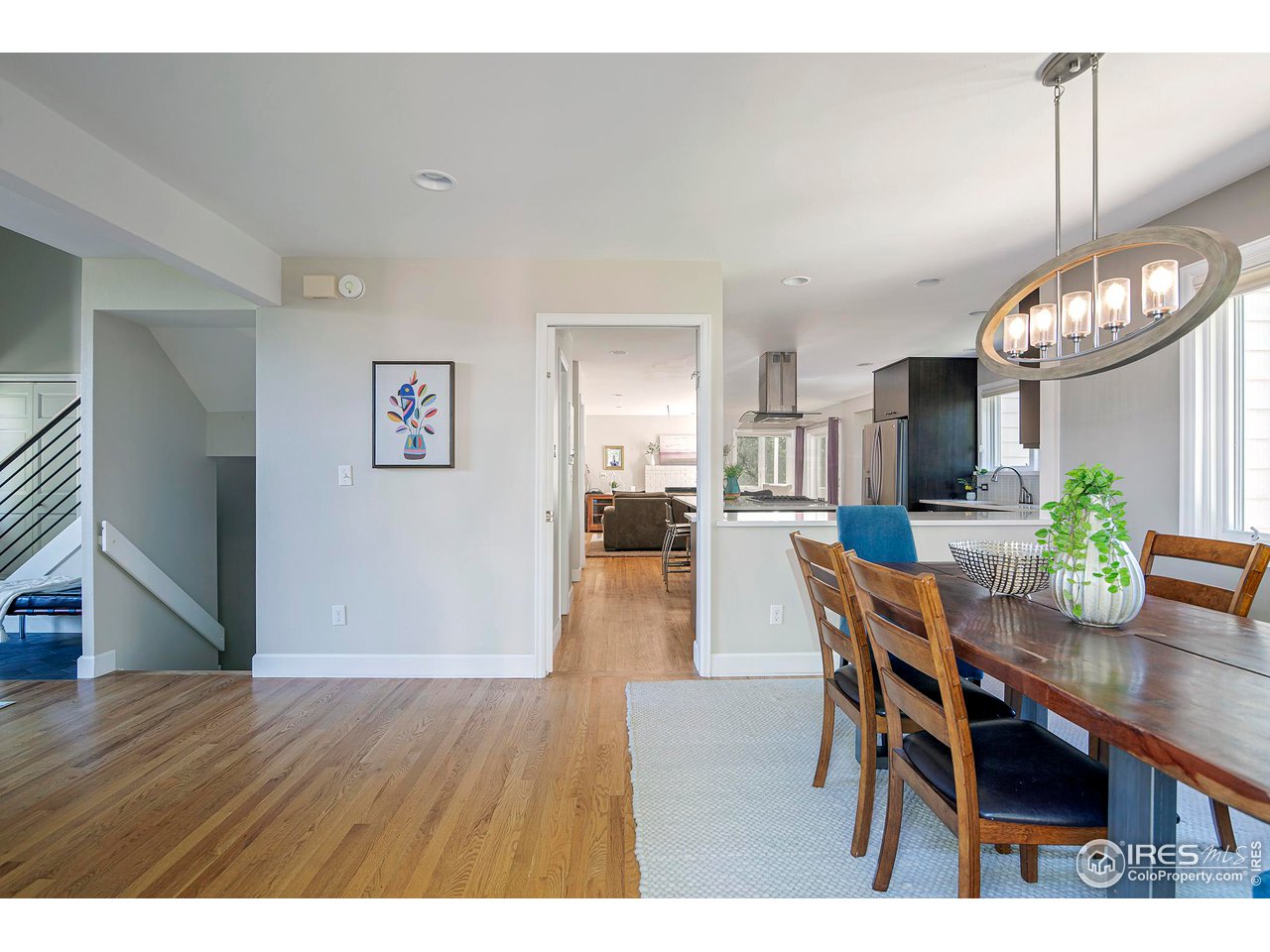 476 Locust Place Boulder, CO 80304 - Photo 38 of 38 a dining room with wooden floor a chandelier a wooden table and chairs