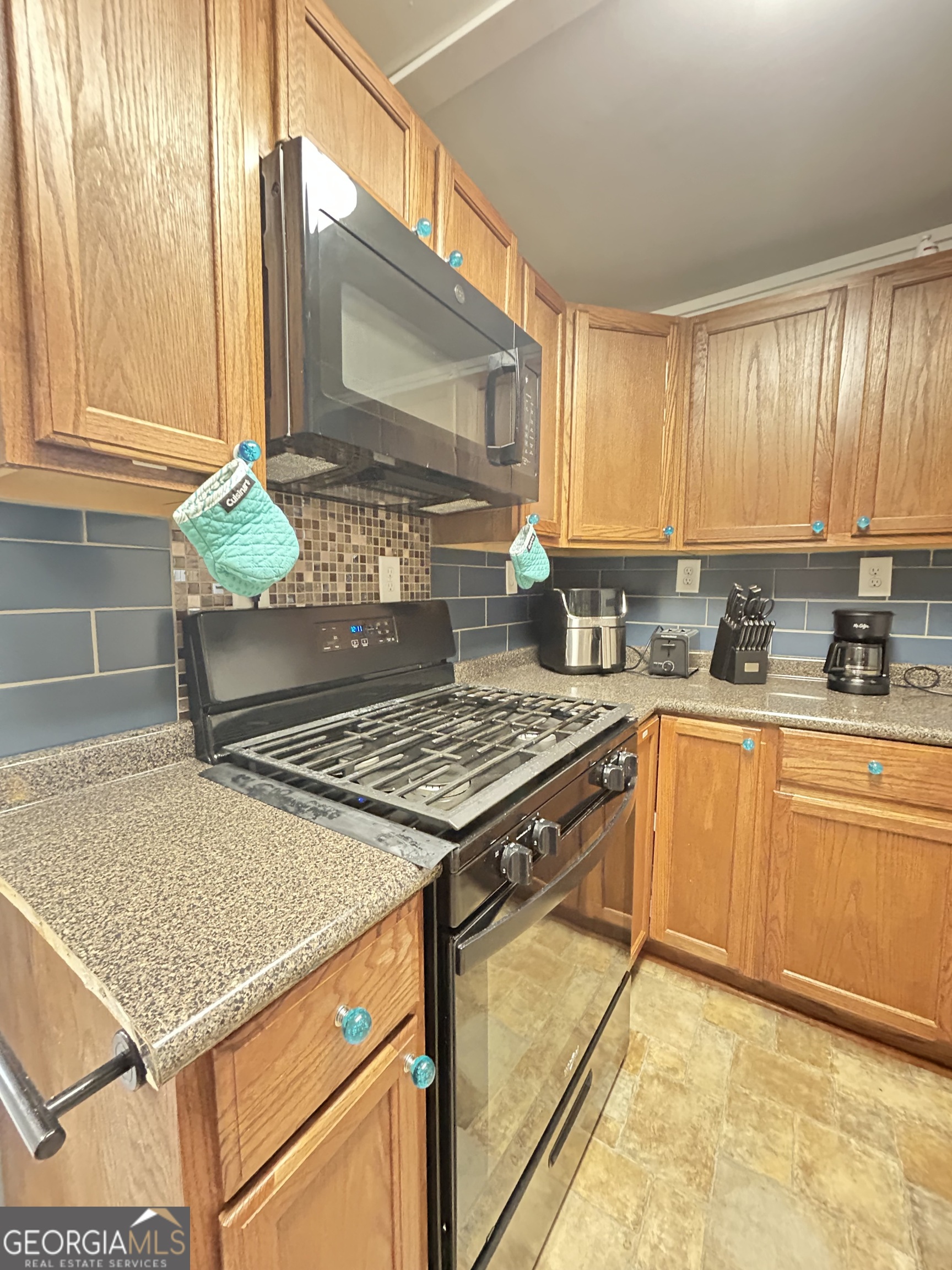 6 Grove Lane Cleveland, GA 30528 - Photo 11 of 40 a kitchen with stainless steel appliances granite countertop a stove a sink and a microwave