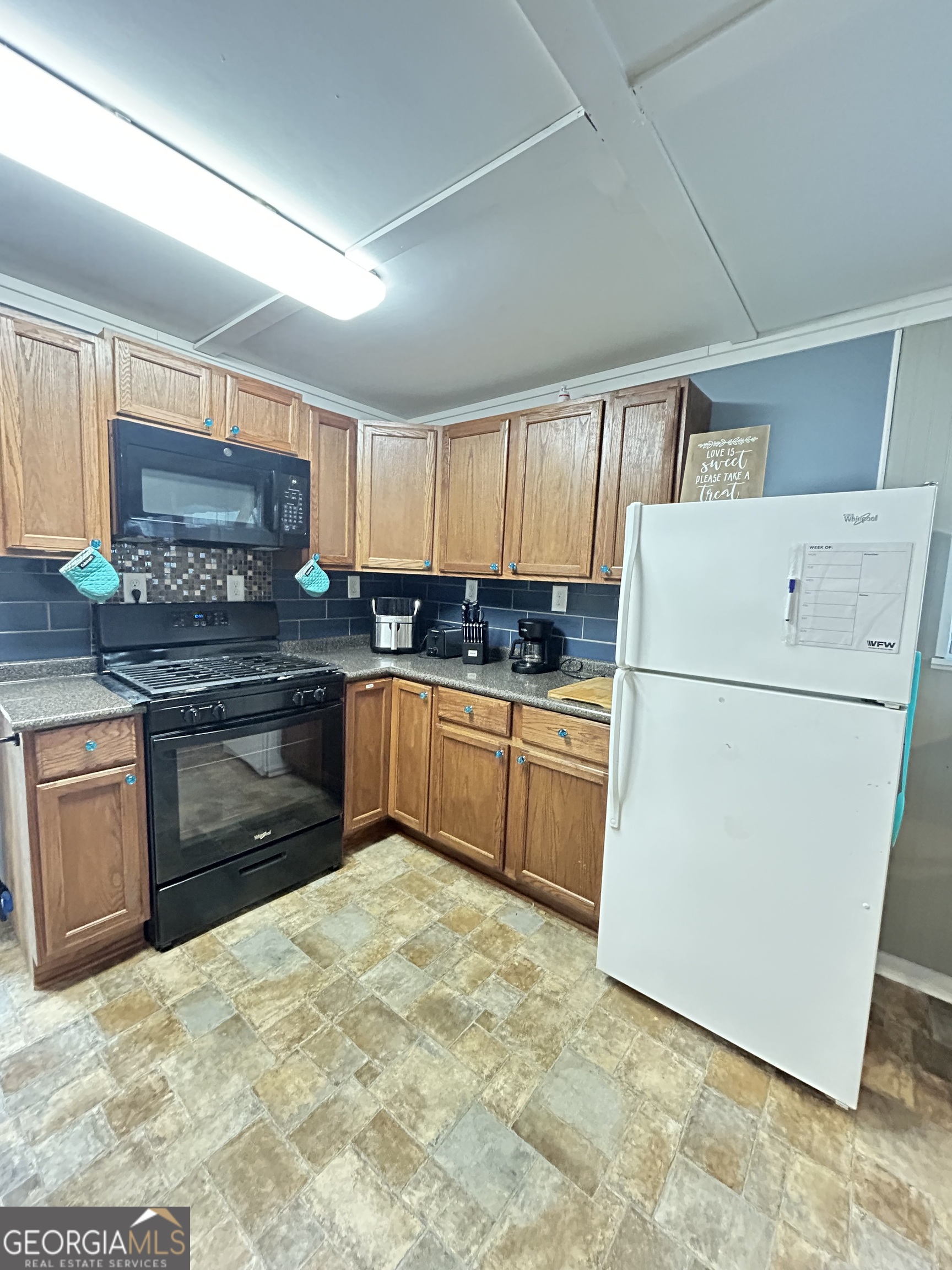 6 Grove Lane Cleveland, GA 30528 - Photo 12 of 40 a kitchen with granite countertop a refrigerator sink stove and cabinets