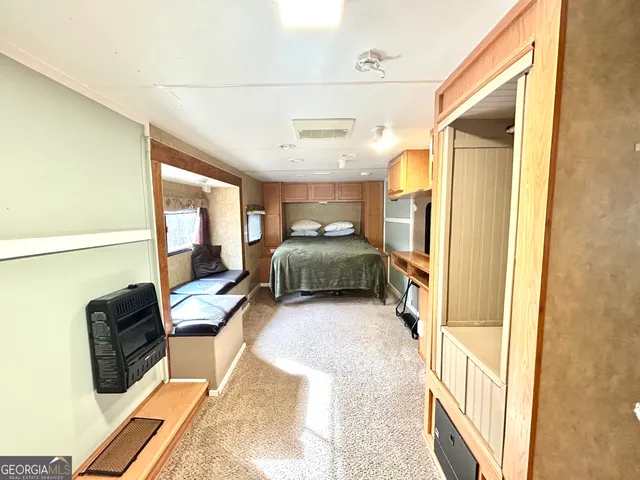 a bedroom with furniture and a wooden floor