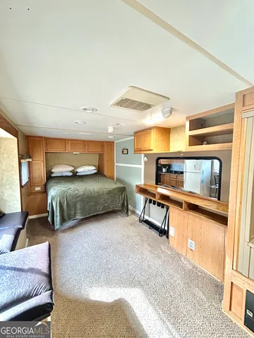 a large bedroom with a bed and a large window with outer view