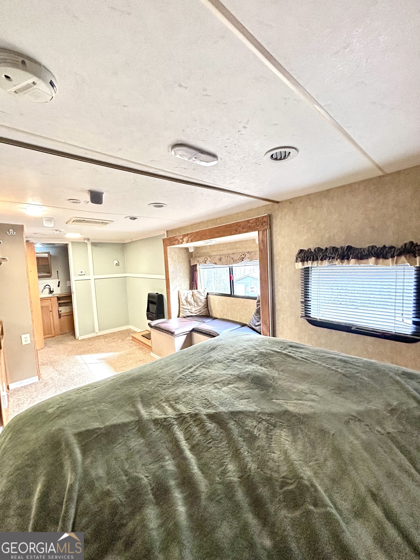 6 Grove Lane Cleveland, GA 30528 - Photo 27 of 40 a large bedroom with a bed and a large window with outer view