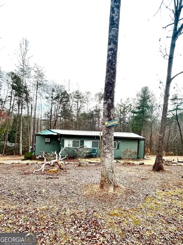 a front view of a building with trees