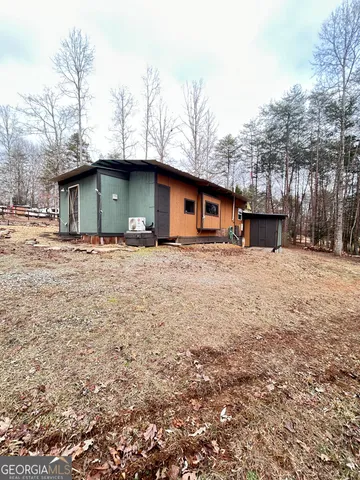 a white house that has a tree in front of it