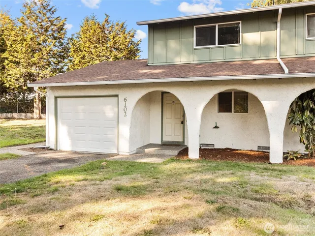 a view of front door and small yard