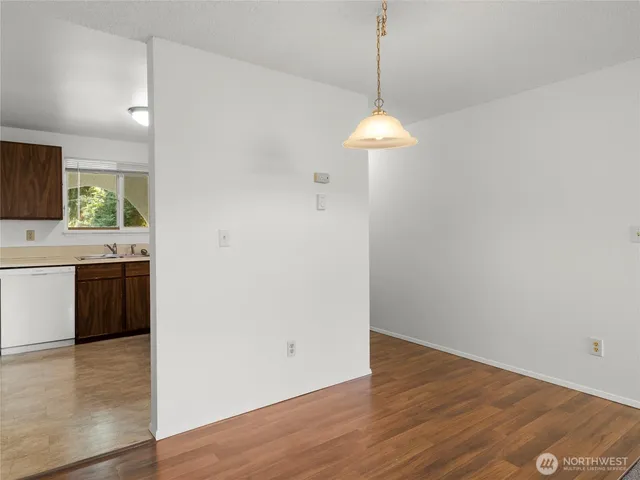 a view of a kitchen with a stove wooden floor and a window