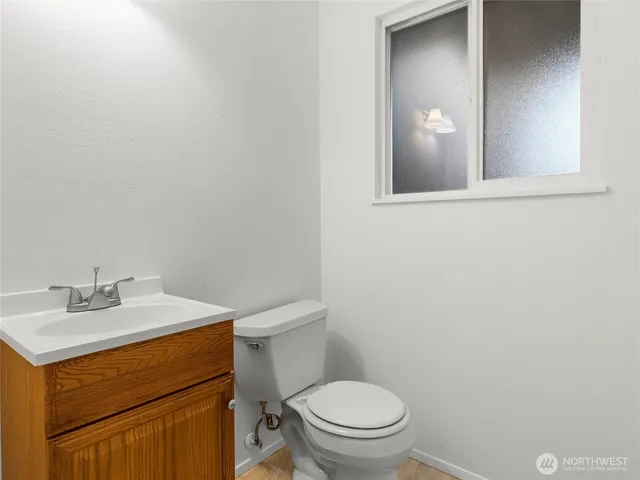 a bathroom with a sink a toilet and mirror