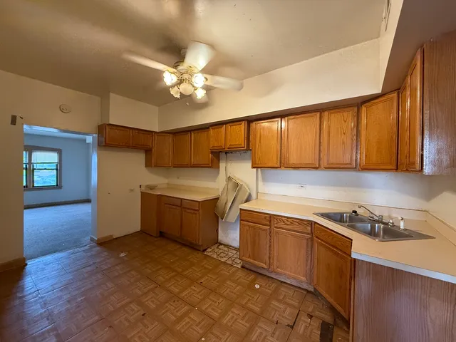 a kitchen with a stove a sink and cabinets