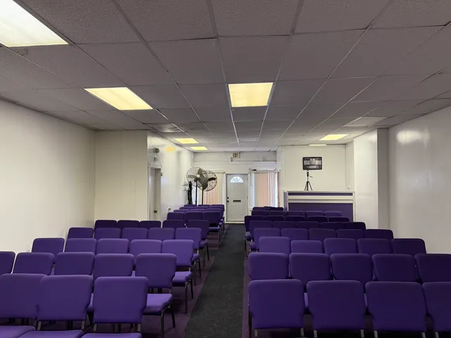 a large room with lots of chairs and a projector