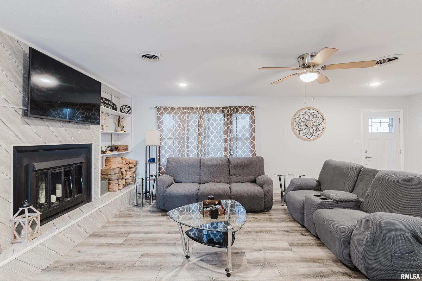 1821 South 27th Street Herrin, IL 62948 - Photo 11 of 35 a living room with furniture a flat screen tv and a fireplace