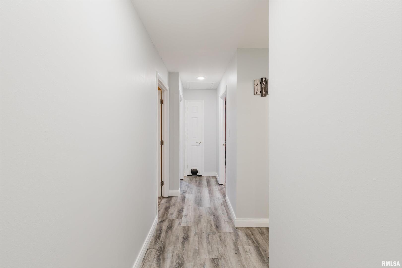 1821 South 27th Street Herrin, IL 62948 - Photo 16 of 35 a view of a hallway with wooden floor and a bathroom