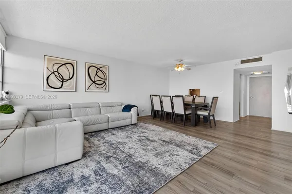 a living room with furniture and wooden floor