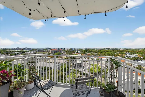 a view of a balcony with furniture