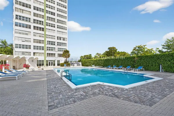 a view of a swimming pool and lounge chair