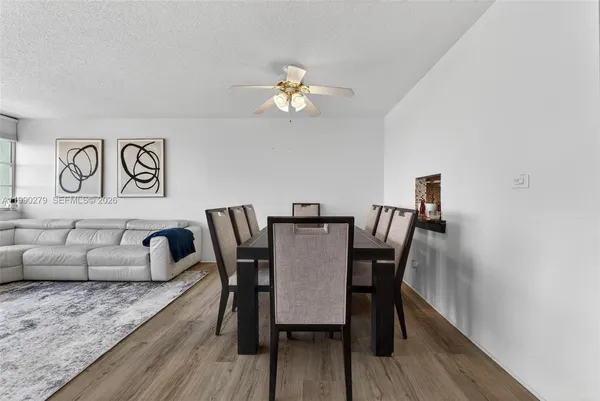 a view of a dining room with furniture and wooden floor