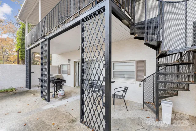 a view of a house with backyard porch and sitting area