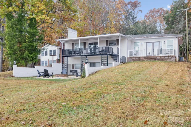 a view of a house with a yard and sitting area