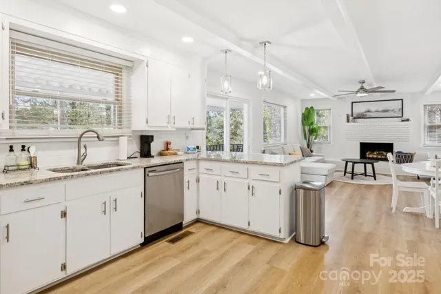 a open kitchen with granite countertop a sink cabinets and window