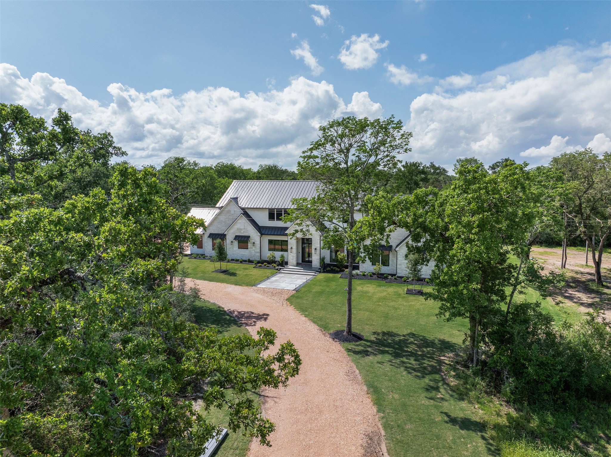 770 South Weyand Road Round Top, TX 78954 - Photo 47 of 50 a aerial view of a house with a yard and a large tree