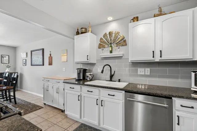 a kitchen with stainless steel appliances granite countertop a sink and cabinets