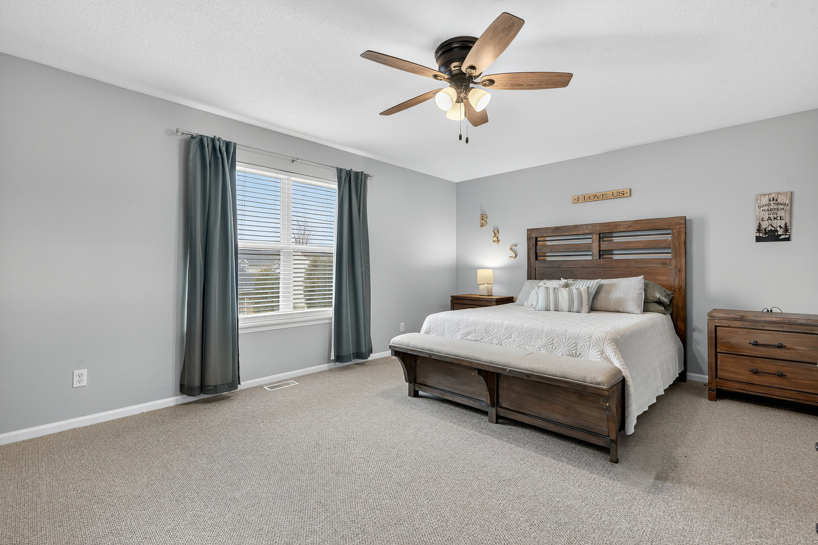 1152 Rose Drive Sycamore, IL 60178 - Photo 18 of 34 a bedroom with a large bed chandelier and a window