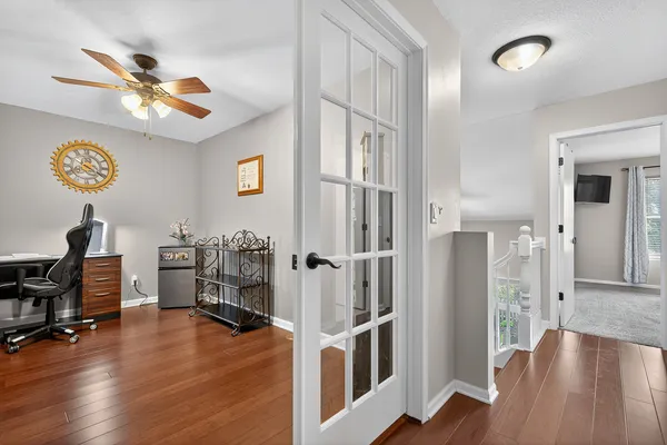 a view of a livingroom with hardwood floor and a ceiling fan