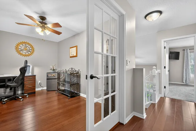 a view of a livingroom with hardwood floor and a ceiling fan