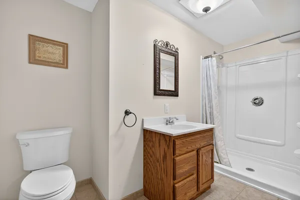 a bathroom with a toilet sink and shower