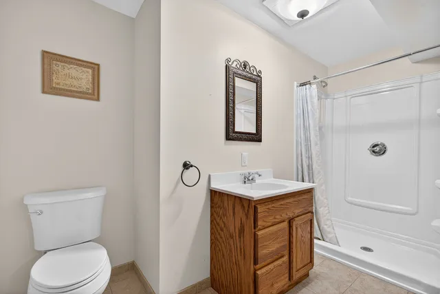 a bathroom with a toilet sink and shower