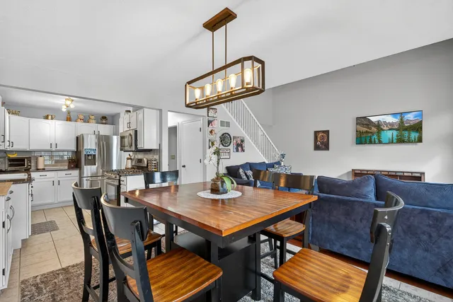 a view of a dining room with furniture and a chandelier