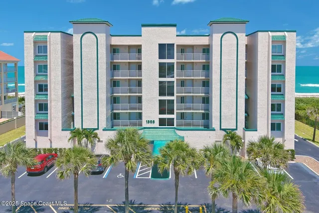 a front view of a building with potted plants